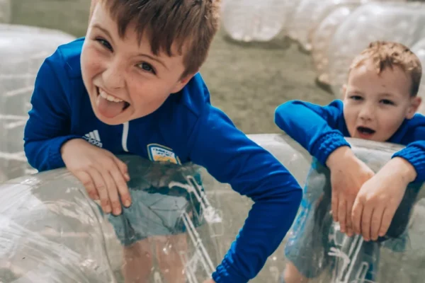 two young boys playing with the Bubble Football