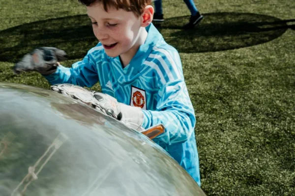 a young boy is playing with bubble balls